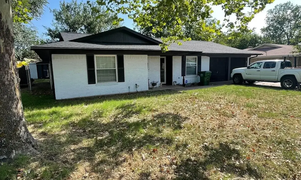 Professional roofing crew working on a residential roof in Clinton